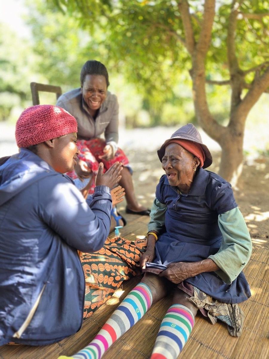 A weekly care visit includes singing, laughter and conversation.