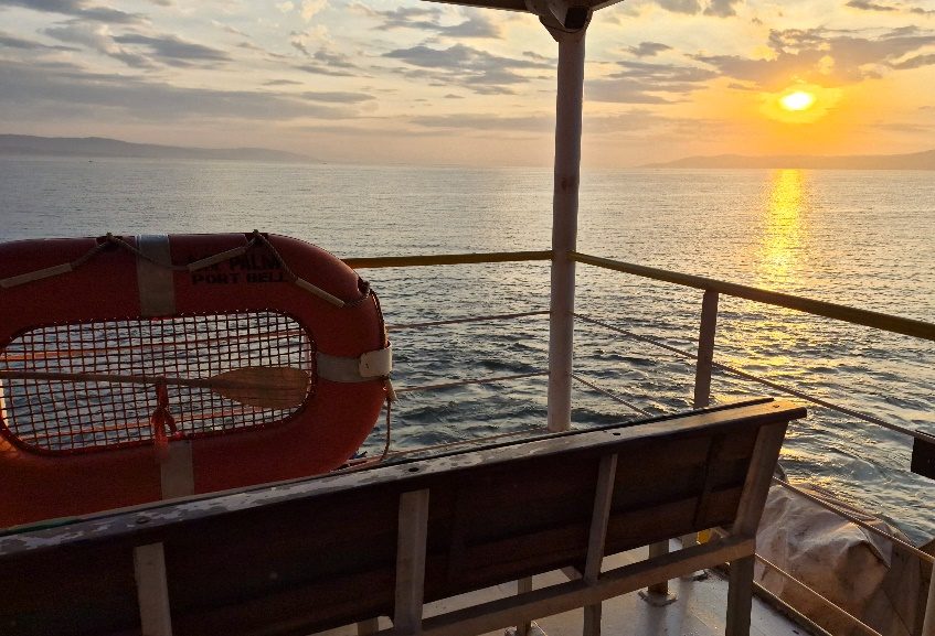 View from the ferry deck across Lake Victoria at sunset